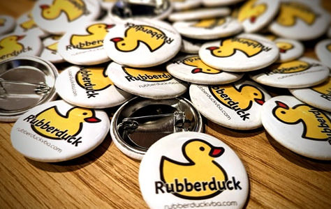 A 38mm button featuring the Rubberduck logo and website...
